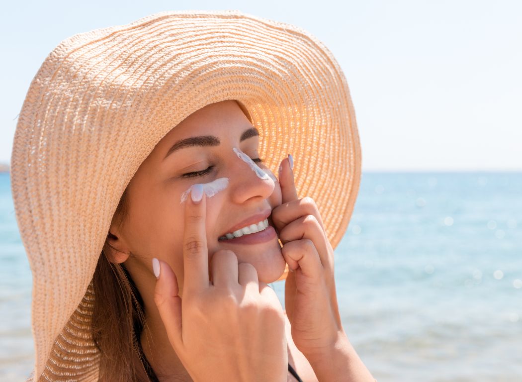 applying sunscreen on face