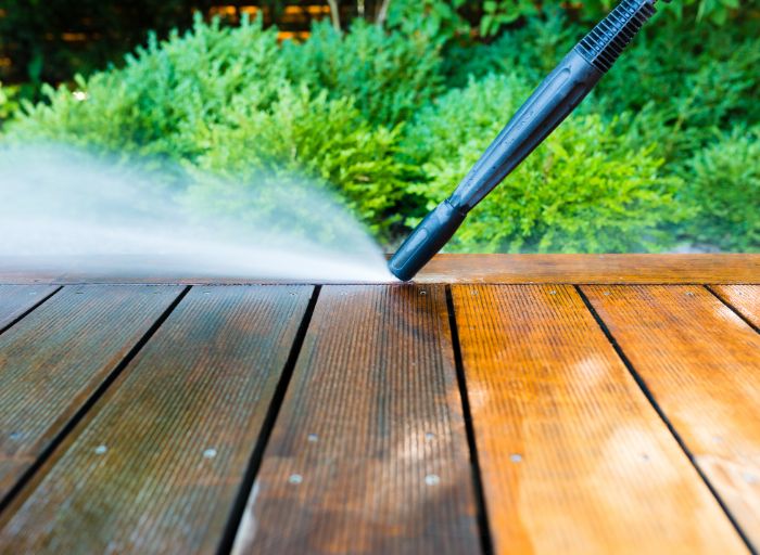 using pressure washer to clean deck